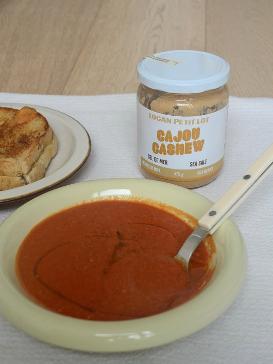 Creamy tomato and cashew butter soup served in a bowl